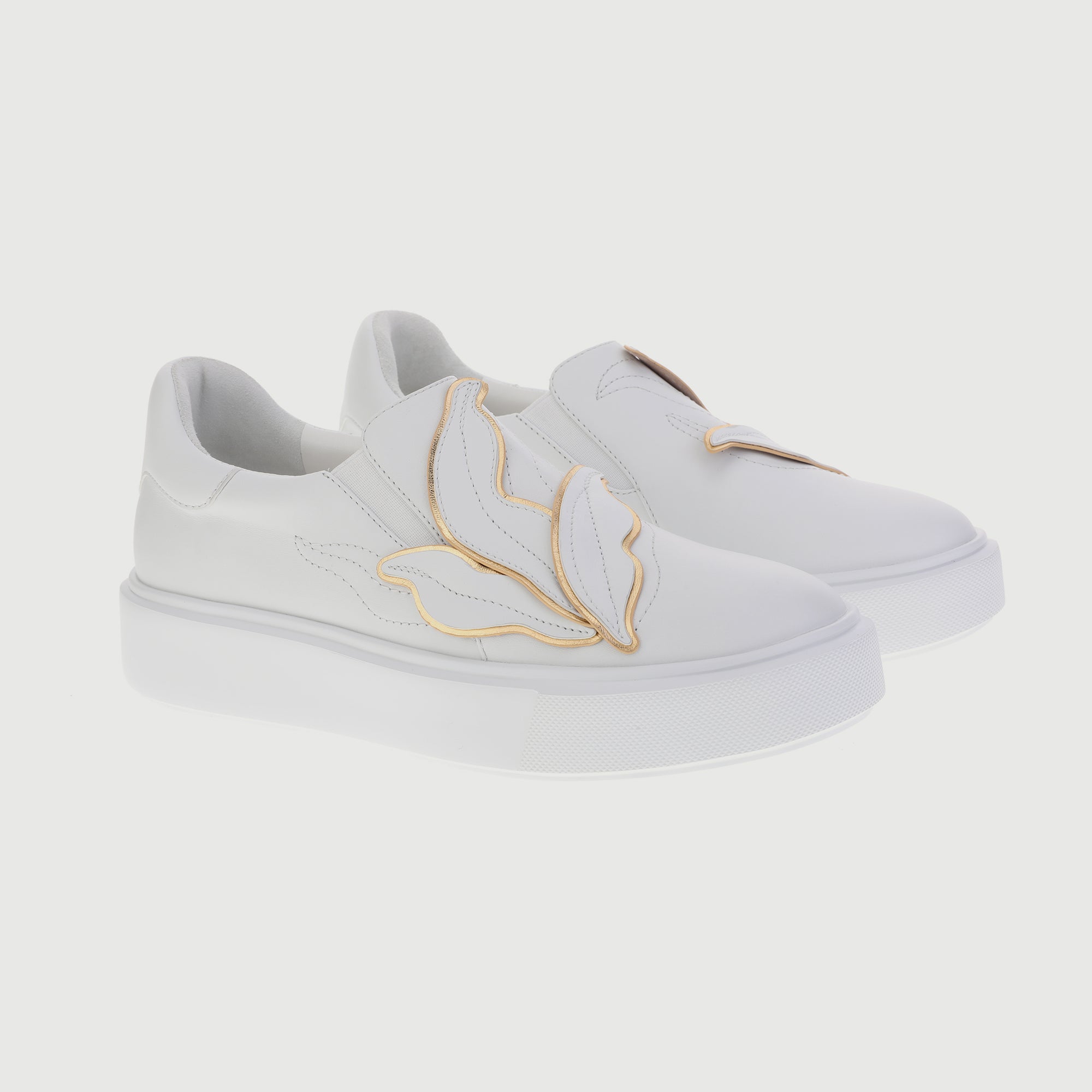 All-white sneakers with embedded leaves